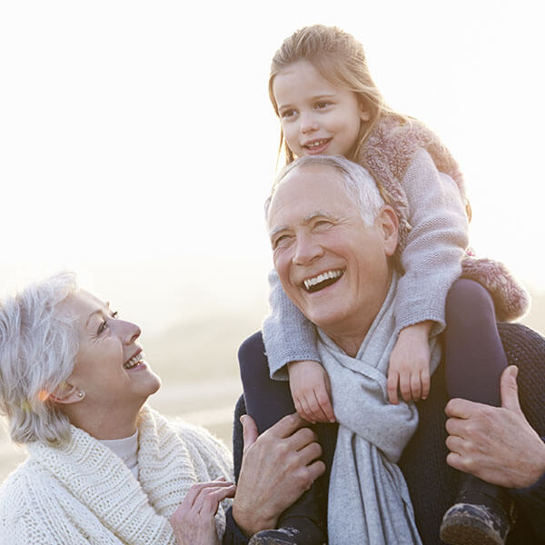 Grand parents playing with their grand daughter