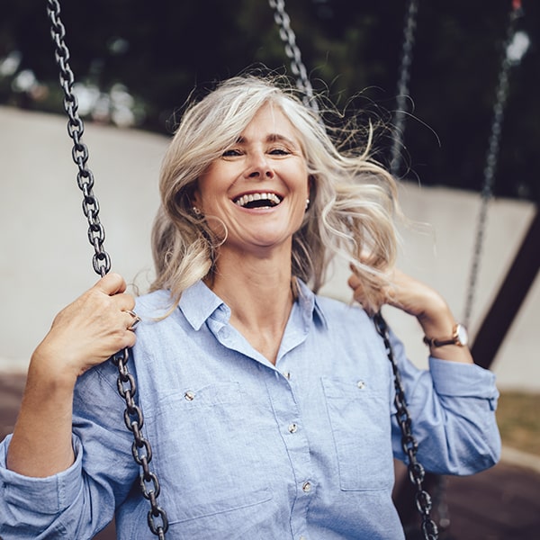 See how our TMJ treatments work with these three easy steps A mature woman swinging while smiling
