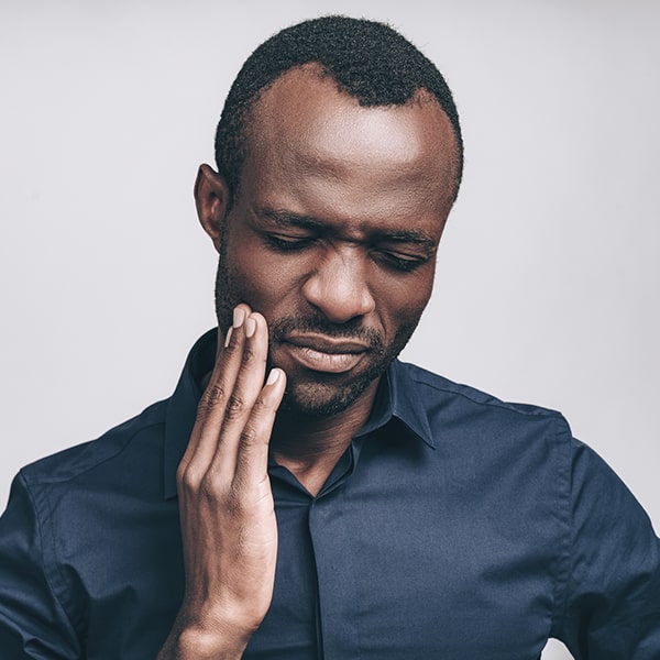 Relieve jaw pain with our dental treatments A man having a jaw pain