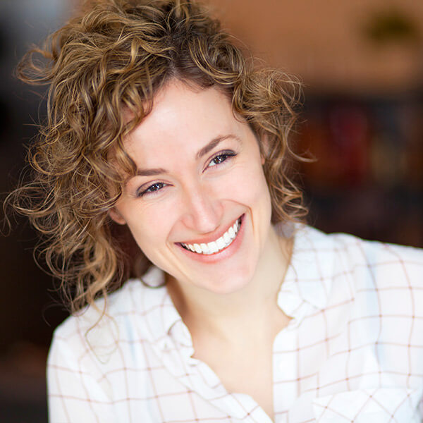 We extract your tooth safely and painlessly with our revolutionized procedures A woman smiling after her tooth extraction