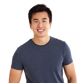 Young man smiling happily about his prepless veneers.
