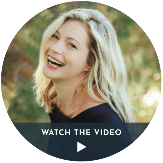 A Lady with a blonde hair and open mouth smile showing leaning towards her left