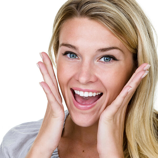 A lady with laughing smile looks surprised and with her arms raised