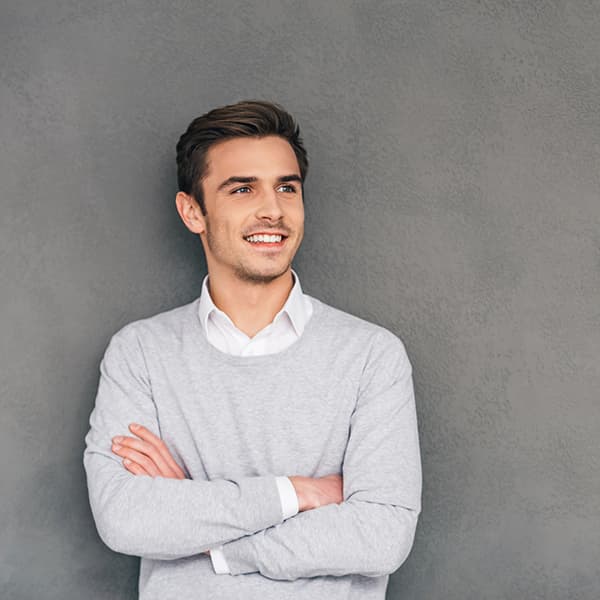 Smiling man with arms crossed A smiling man wearing a sweatshirt with arms crossed