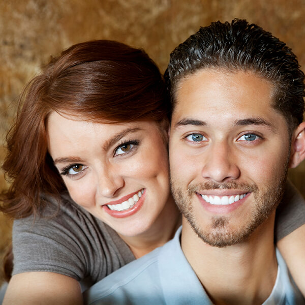 Side by Side Faces A man and a woman back hugging with their faces side by side