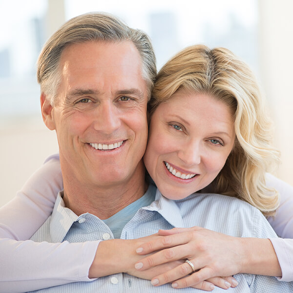 Lady back hugging A smiling lady back hugs a smiling man