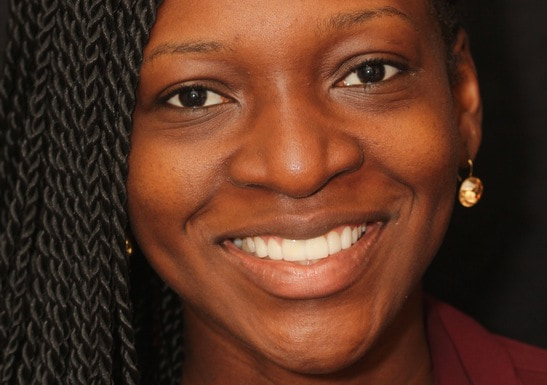 A woman is smiling