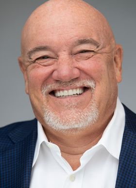 Dr. Eric Farmer is happily smiling